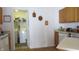 A bright kitchen area with wood cabinets and view of laundry room with washer and dryer at 1833 Southernwood Ln, Indianapolis, IN 46231