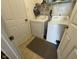 A laundry room with a washer and dryer, shelving and tile flooring at 1833 Southernwood Ln, Indianapolis, IN 46231