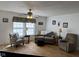 A comfortable living room with a ceiling fan, seating arrangement, and window at 1833 Southernwood Ln, Indianapolis, IN 46231