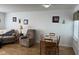 A cozy living room area with a sofa, recliner, table and chairs, and natural light at 1833 Southernwood Ln, Indianapolis, IN 46231