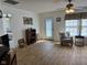 Bright living room with wood floors, a ceiling fan, and decoratively adorned walls at 1833 Southernwood Ln, Indianapolis, IN 46231