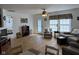 Open-concept living room featuring wood floors, a ceiling fan, and plenty of natural light at 1833 Southernwood Ln, Indianapolis, IN 46231
