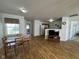 A living and dining space showcasing wood-look flooring, tv, and view to kitchen at 1833 Southernwood Ln, Indianapolis, IN 46231