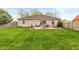 Spacious backyard featuring a concrete patio with outdoor seating and well-manicured lawn at 204 S Hougland St, Trafalgar, IN 46181