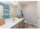 Bright bathroom with a large mirror, white countertop, and wood-finished cabinets at 204 S Hougland St, Trafalgar, IN 46181