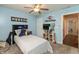 Bedroom with light blue walls, carpeted floors, ceiling fan, and connected to other rooms at 204 S Hougland St, Trafalgar, IN 46181
