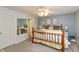 Bedroom with bed, matching nightstands, carpeted floors, and a walk-in closet at 204 S Hougland St, Trafalgar, IN 46181