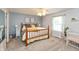 Bedroom featuring light blue walls, carpeted floors, a ceiling fan, and a bed at 204 S Hougland St, Trafalgar, IN 46181