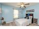 Cozy bedroom with blue walls, carpeted floors, a ceiling fan, and a twin bed at 204 S Hougland St, Trafalgar, IN 46181