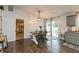 Dining area featuring a modern farmhouse table, sliding doors, and access to the kitchen at 204 S Hougland St, Trafalgar, IN 46181