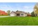 Well-maintained single-story home with green lawn, attached garage, and classic design at 204 S Hougland St, Trafalgar, IN 46181
