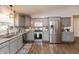A kitchen featuring gray cabinets, stainless steel appliances, and hardwood floors at 204 S Hougland St, Trafalgar, IN 46181