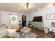 Bright living room featuring a ceiling fan, hardwood floors, and cozy decor at 204 S Hougland St, Trafalgar, IN 46181