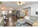 Open-concept living room showcasing hardwood floors, comfortable seating, and a seamless flow to the kitchen at 204 S Hougland St, Trafalgar, IN 46181