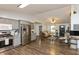 Open-concept living space with hardwood floors, gray cabinets, and seamless flow between living and kitchen at 204 S Hougland St, Trafalgar, IN 46181