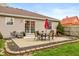 Back patio area with outdoor seating, a grill, and mature landscaping at 204 S Hougland St, Trafalgar, IN 46181