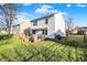 View of the home's backyard, featuring a deck, green lawn, and a black chain link fence at 209 Allen Ln, New Whiteland, IN 46184