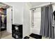 Clean bathroom with shower-tub combo, tile floors, and access to the walk-in closet at 209 Allen Ln, New Whiteland, IN 46184