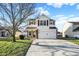 Charming two-story home featuring a manicured lawn and an attached two-car garage at 209 Allen Ln, New Whiteland, IN 46184