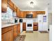 Bright kitchen with light wood cabinets, white appliances, and a cozy atmosphere at 209 Allen Ln, New Whiteland, IN 46184