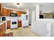 Functional kitchen with wood cabinets, modern appliances, and a convenient breakfast area at 209 Allen Ln, New Whiteland, IN 46184