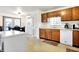 Open-concept kitchen with ample counter space, wood cabinets, and a dining area at 209 Allen Ln, New Whiteland, IN 46184