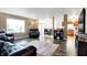 Inviting living room with dark wood floors, view to backyard, and sliding glass doors to dining at 209 Allen Ln, New Whiteland, IN 46184