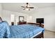 Well-lit main bedroom with carpet floors, TV, dresser, and door to en-suite bathroom at 209 Allen Ln, New Whiteland, IN 46184