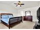 Bright main bedroom featuring carpet floors, ceiling fan, and en-suite bathroom at 209 Allen Ln, New Whiteland, IN 46184