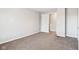 Spacious bedroom with neutral walls, carpet, and a doorway at 2114 N Dexter St, Indianapolis, IN 46202