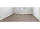 Inviting bedroom featuring neutral carpeting, a window, and crisp, neutral paint at 2114 N Dexter St, Indianapolis, IN 46202