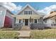Well-maintained home featuring gray siding, a covered porch, and landscaped front yard at 2114 N Dexter St, Indianapolis, IN 46202