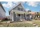 Charming home with gray siding, a covered porch, and a small front yard at 2114 N Dexter St, Indianapolis, IN 46202
