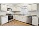 Modern kitchen featuring stainless steel appliances, white cabinets and countertops, and hardwood floors at 2114 N Dexter St, Indianapolis, IN 46202