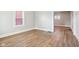 Bright living room with modern flooring, fresh paint, and access to other rooms at 2114 N Dexter St, Indianapolis, IN 46202