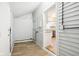 Functional mud room with wooden siding, hardwood flooring, and convenient kitchen access at 2114 N Dexter St, Indianapolis, IN 46202