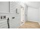 Functional mud room featuring white wooden siding, hardwood flooring, and convenient access at 2114 N Dexter St, Indianapolis, IN 46202