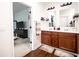 Bathroom featuring a double sink vanity with dark wood cabinets and hard surface countertops at 2239 E Werges Ave, Indianapolis, IN 46237