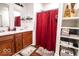 Bathroom with a double sink vanity, shower with curtain, and built in storage at 2239 E Werges Ave, Indianapolis, IN 46237
