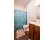 Bathroom with laminate wood floor, decorative shower curtain and single sink vanity at 2239 E Werges Ave, Indianapolis, IN 46237