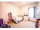 bedroom with light purple accents, carpeted floors and a window for natural light at 2239 E Werges Ave, Indianapolis, IN 46237