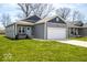 Well-maintained single-story house with an attached garage and a beautifully landscaped lawn at 2239 E Werges Ave, Indianapolis, IN 46237