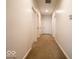 Clean, carpeted hallway with neutral walls and multiple doors leading to various rooms at 2239 E Werges Ave, Indianapolis, IN 46237