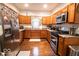 Well-equipped kitchen with stainless steel appliances, wood cabinets, and granite countertops at 2239 E Werges Ave, Indianapolis, IN 46237