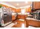 Spacious kitchen featuring stainless steel appliances, wooden cabinetry, and a cozy breakfast nook at 2239 E Werges Ave, Indianapolis, IN 46237