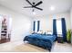 Bright bedroom with a ceiling fan, carpeted floor, and walk in closet at 2239 E Werges Ave, Indianapolis, IN 46237