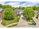 Aerial view of a brick and siding home with mature trees and a long driveway at 2303 Cole Wood Ct, Indianapolis, IN 46239