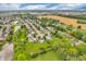 This aerial view highlights the community's serene environment with a pond and proximity to fields, creating an inviting landscape at 2303 Cole Wood Ct, Indianapolis, IN 46239