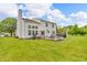 Expansive backyard with a large patio, outdoor seating, and a well-maintained lawn at 2303 Cole Wood Ct, Indianapolis, IN 46239