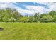 Serene backyard with lush green grass and mature trees, perfect for relaxation at 2303 Cole Wood Ct, Indianapolis, IN 46239